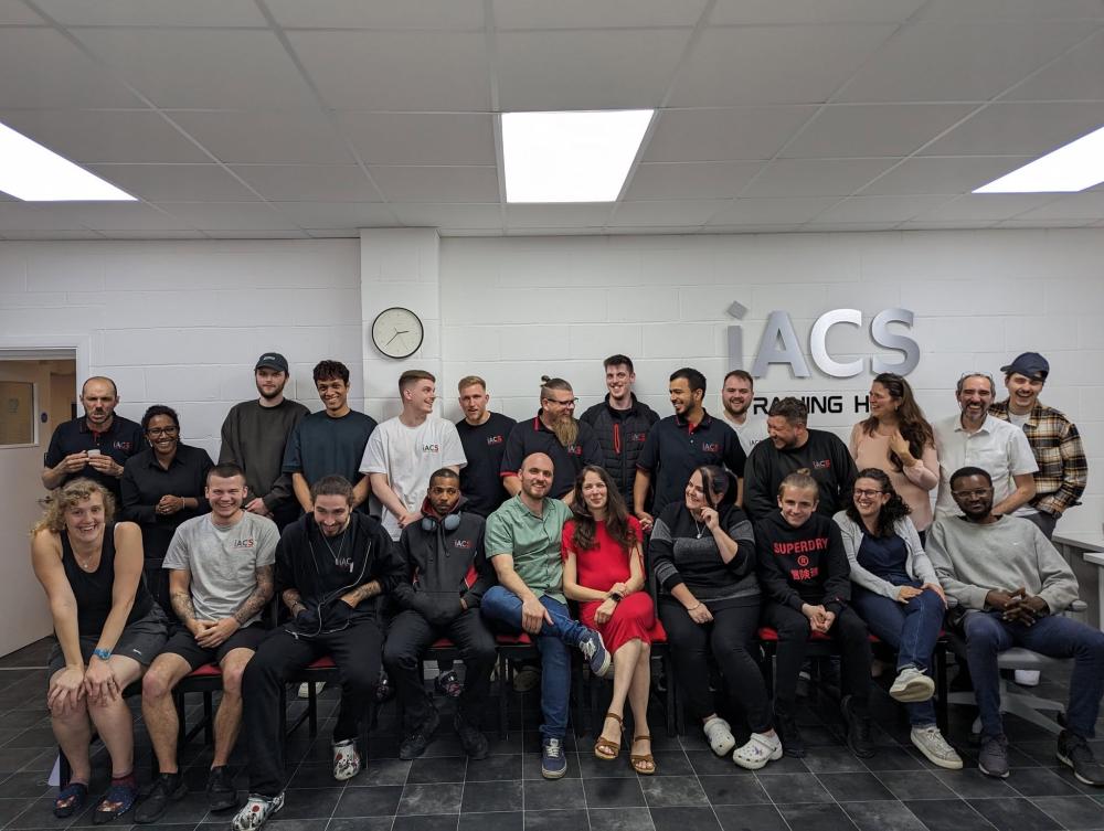 A group photo of the entire iACS team of employees and specialists gathered together in the company's training hub.